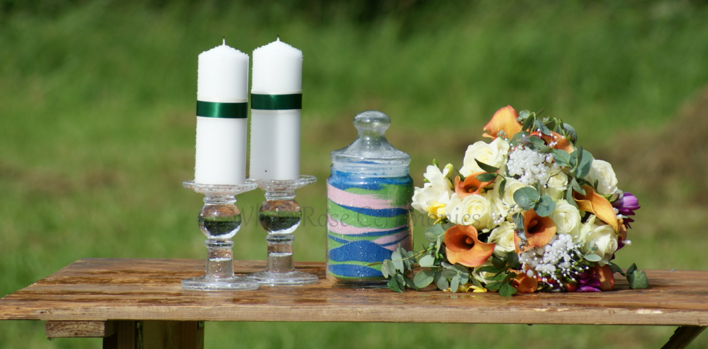 Sand Unity Ceremony jar with candles and flowers